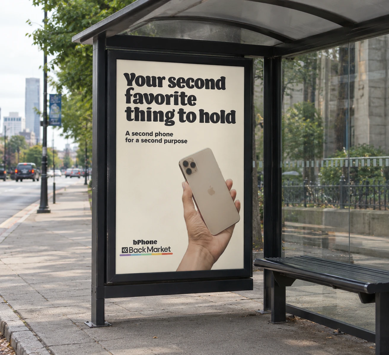 Bus shelter poster: a hand holding up a gold iPhone, 'Your second favorite thing to hold'