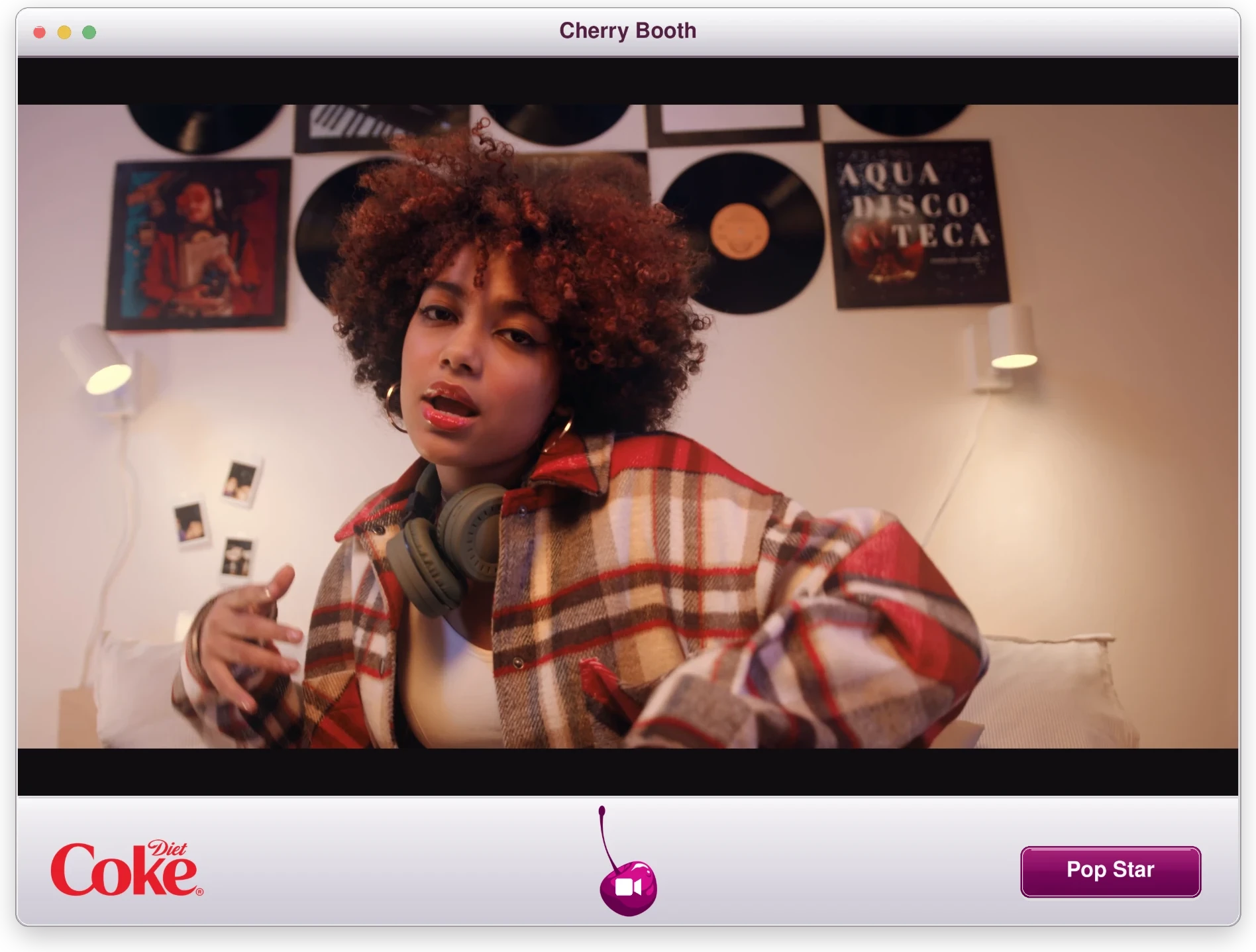 The Cherry Booth: a Diet Coke app window with a young woman singing to camera, a cherry record button and a 'Pop Star' button