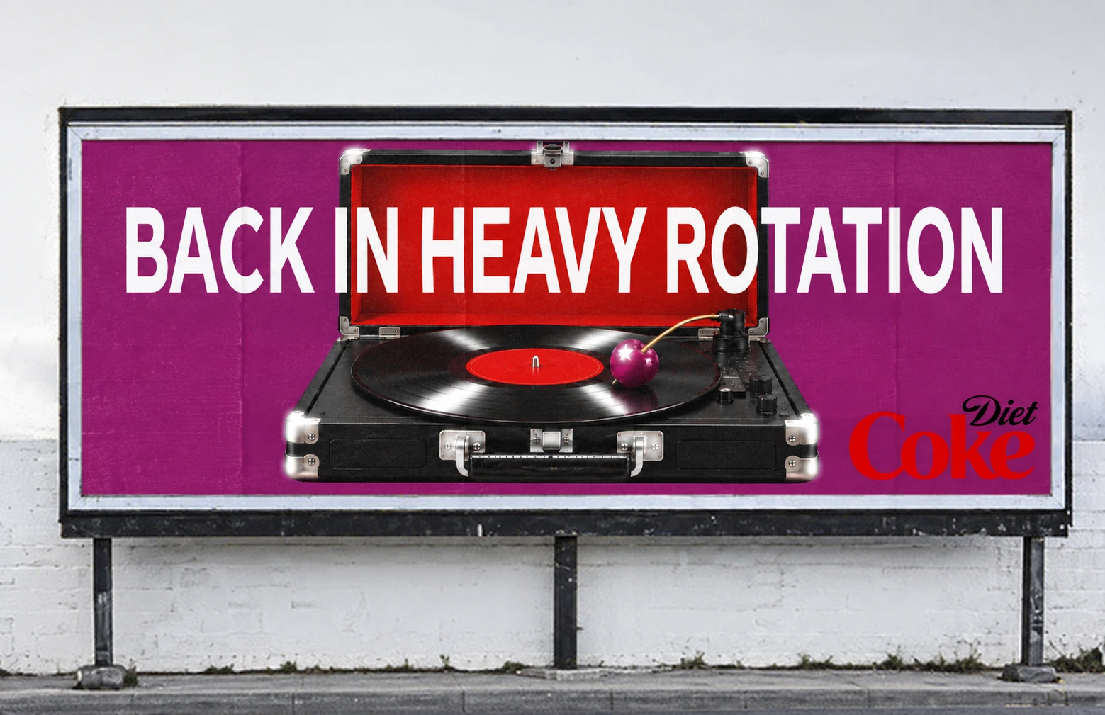 Billboard: 'Back in heavy rotation' over a record player with a cherry as the needle, Diet Coke logo
